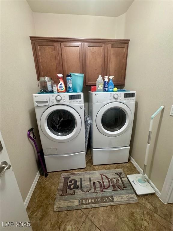 6614 Collingsworth St, Las Vegas, NV 89131 - laundry room with washing machine and clothes dryer, cabinet space, and light tile patterned floors