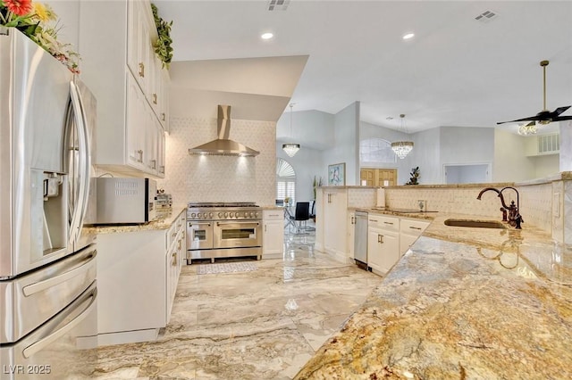 1970 Del Font Ct, Las Vegas, NV 89117 - kitchen featuring stainless steel appliances, wall chimney range hood, decorative backsplash, white cabinets, and light stone counters