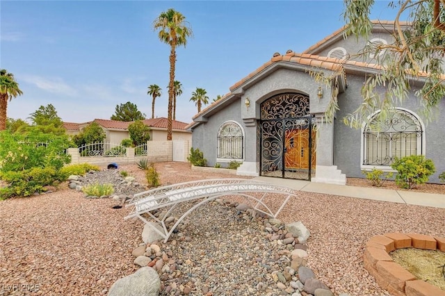 1970 Del Font Ct, Las Vegas, NV 89117 - mediterranean / spanish-style house with a tiled roof, stucco siding, and a gate