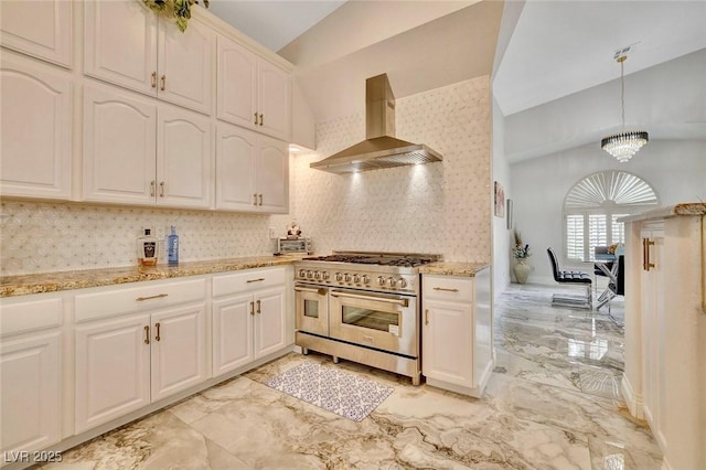 1970 Del Font Ct, Las Vegas, NV 89117 - kitchen with range with two ovens, wall chimney range hood, lofted ceiling, light marble finish floors, and tasteful backsplash