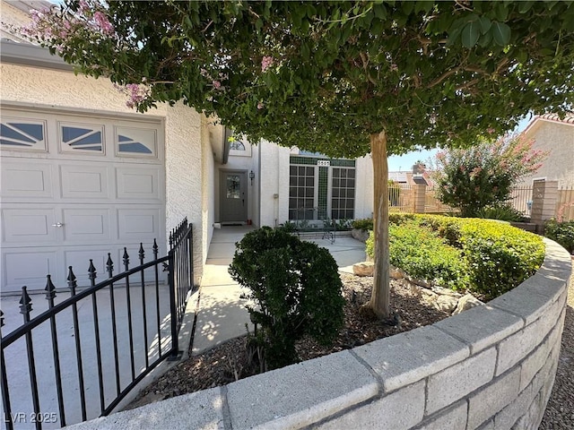5505 Excelsior Springs Ln, Las Vegas, NV 89130 - view of exterior entry featuring an attached garage and stucco siding