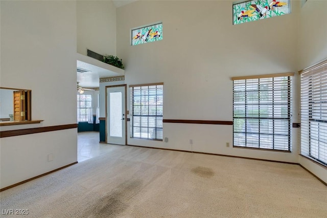 5505 Excelsior Springs Ln, Las Vegas, NV 89130 - unfurnished living room featuring a high ceiling, carpet flooring, and a ceiling fan