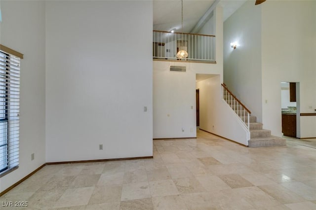 5505 Excelsior Springs Ln, Las Vegas, NV 89130 - unfurnished living room with high vaulted ceiling, plenty of natural light, and stairs