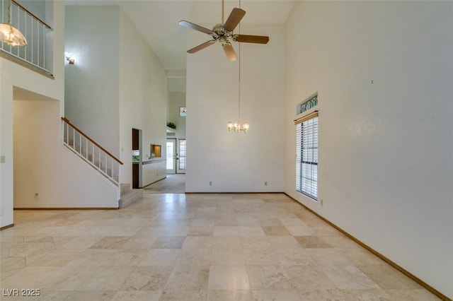 5505 Excelsior Springs Ln, Las Vegas, NV 89130 - unfurnished living room with high vaulted ceiling, ceiling fan, stairway, and a chandelier