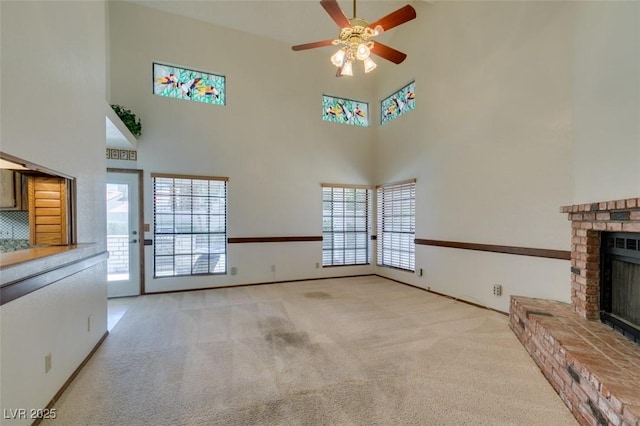 5505 Excelsior Springs Ln, Las Vegas, NV 89130 - unfurnished living room featuring a fireplace, a towering ceiling, ceiling fan, and carpet