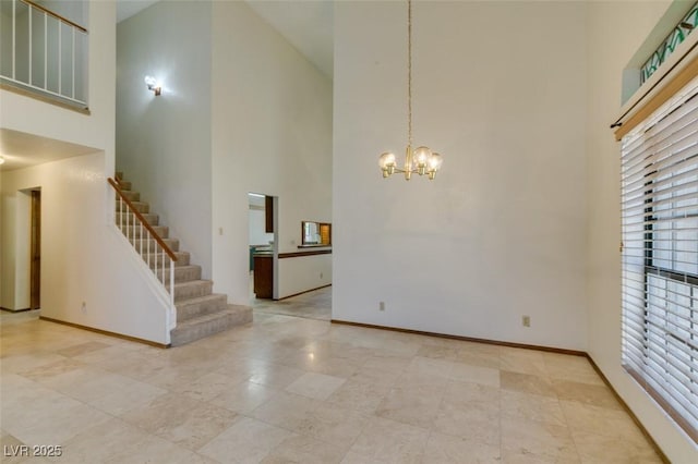 5505 Excelsior Springs Ln, Las Vegas, NV 89130 - unfurnished living room with a high ceiling, a chandelier, and stairs