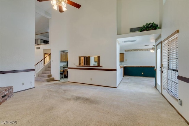 5505 Excelsior Springs Ln, Las Vegas, NV 89130 - unfurnished living room featuring a towering ceiling, ceiling fan, carpet, and stairs