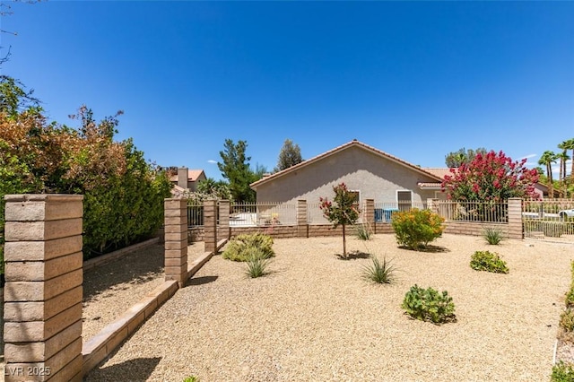 5505 Excelsior Springs Ln, Las Vegas, NV 89130 - view of home's exterior with stucco siding and a gate