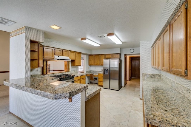 5505 Excelsior Springs Ln, Las Vegas, NV 89130 - kitchen with stainless steel refrigerator with ice dispenser, range with gas cooktop, open shelves, under cabinet range hood, and a peninsula