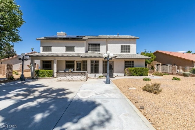 5505 Excelsior Springs Ln, Las Vegas, NV 89130 - view of front facade featuring stucco siding, solar panels, and a patio area