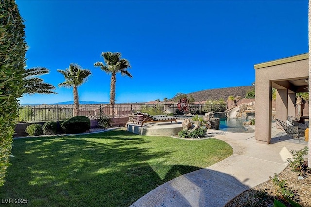 2172 De Rouge Ave, Henderson, NV 89044 - fenced backyard with a patio and a mountain view