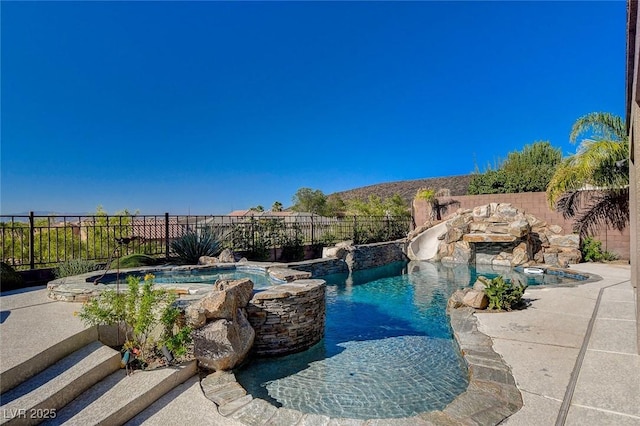 2172 De Rouge Ave, Henderson, NV 89044 - view of swimming pool featuring a fenced backyard, a pool with connected hot tub, and a water slide