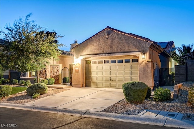 2172 De Rouge Ave, Henderson, NV 89044 - view of front of home featuring a gate, an attached garage, stucco siding, concrete driveway, and a tiled roof