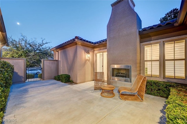 2172 De Rouge Ave, Henderson, NV 89044 - view of patio / terrace with a gate, a multi sided fireplace, and heating unit