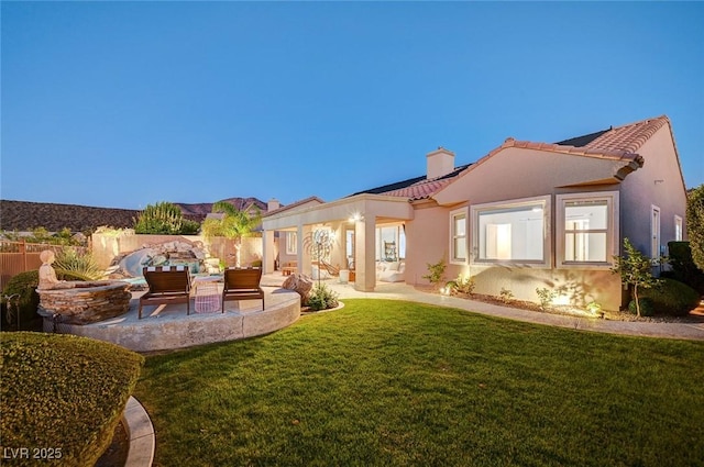 2172 De Rouge Ave, Henderson, NV 89044 - back of property featuring a tiled roof, a patio, a chimney, stucco siding, and an outdoor living space