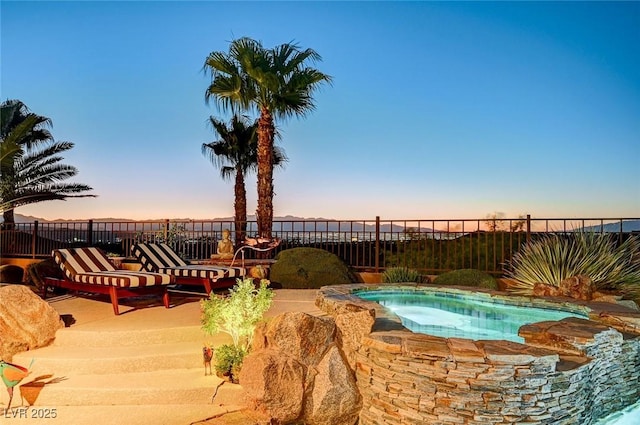 2172 De Rouge Ave, Henderson, NV 89044 - pool at dusk featuring an in-ground hot tub