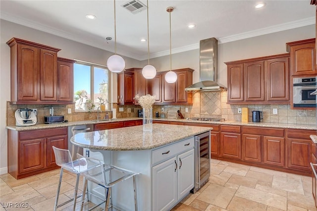 2172 De Rouge Ave, Henderson, NV 89044 - kitchen with wall chimney exhaust hood, wine cooler, a center island, stainless steel appliances, and pendant lighting