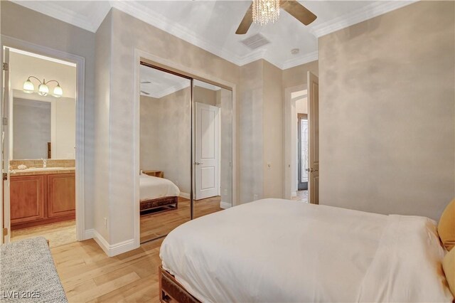 2172 De Rouge Ave, Henderson, NV 89044 - bedroom featuring light wood finished floors, ornamental molding, ensuite bath, a closet, and ceiling fan
