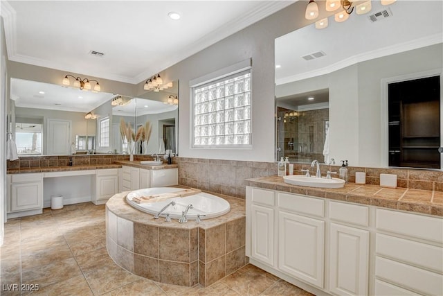 2172 De Rouge Ave, Henderson, NV 89044 - bathroom with ornamental molding, a garden tub, vanity, a shower stall, and tile patterned flooring