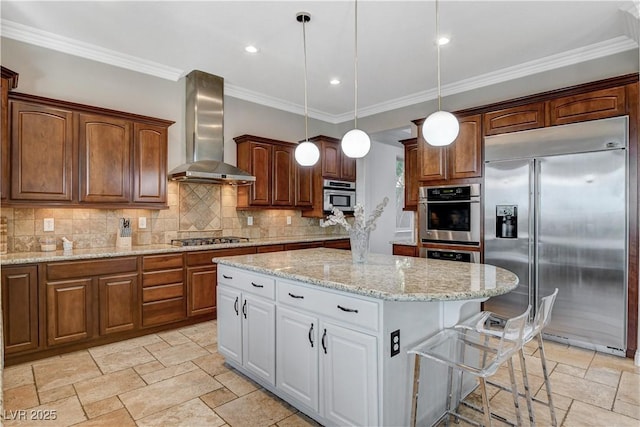 2172 De Rouge Ave, Henderson, NV 89044 - kitchen featuring appliances with stainless steel finishes, wall chimney exhaust hood, stone tile flooring, a kitchen island, and tasteful backsplash