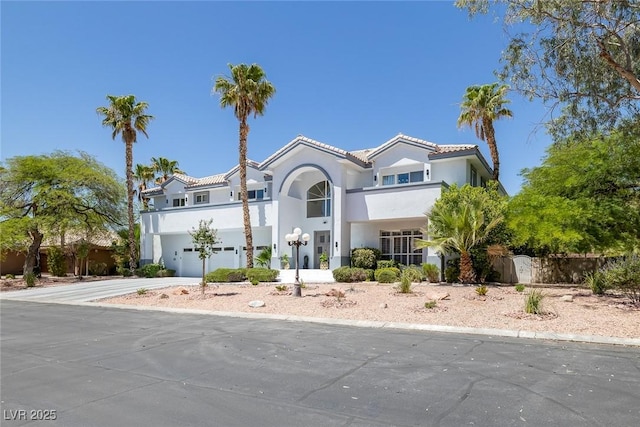 2209 Purple Majesty Ct, Las Vegas, NV 89117 - mediterranean / spanish-style house featuring a garage, stucco siding, concrete driveway, and a tile roof