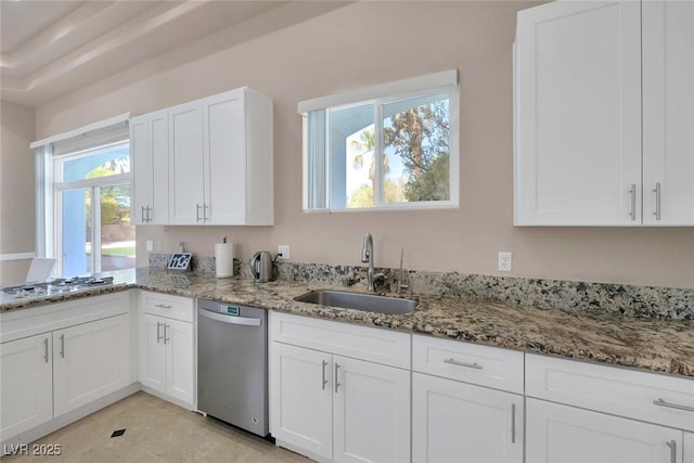 2209 Purple Majesty Ct, Las Vegas, NV 89117 - kitchen featuring stainless steel dishwasher, white gas stovetop, white cabinets, and light stone counters