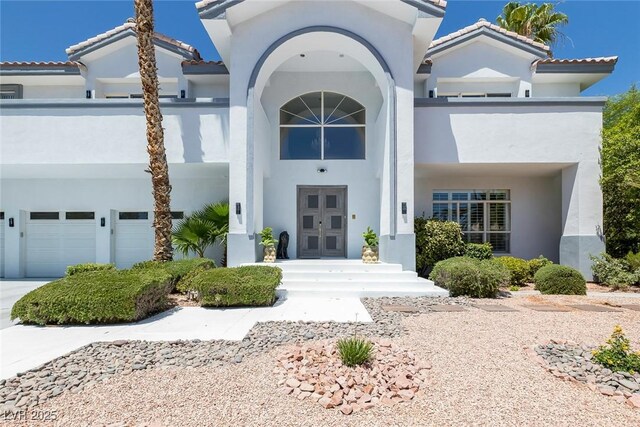 2209 Purple Majesty Ct, Las Vegas, NV 89117 - property entrance with stucco siding, french doors, and a garage