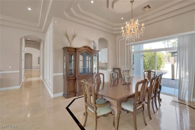 2209 Purple Majesty Ct, Las Vegas, NV 89117 - dining room featuring arched walkways, a tray ceiling, a chandelier, a high ceiling, and recessed lighting