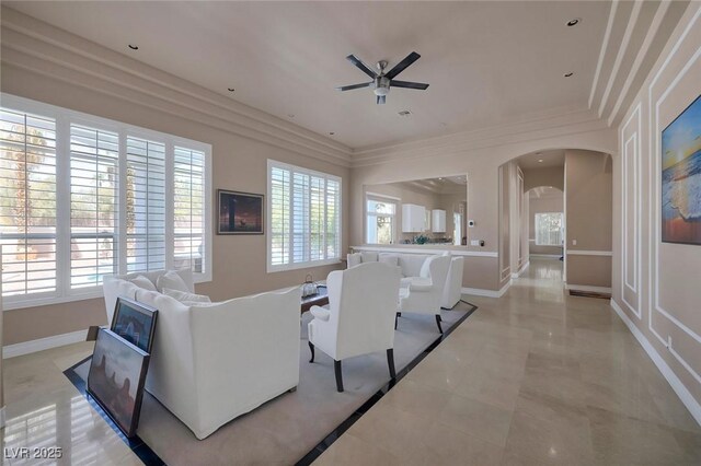 2209 Purple Majesty Ct, Las Vegas, NV 89117 - living room with arched walkways, a ceiling fan, and crown molding