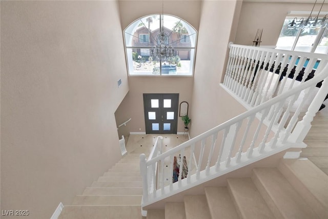 2209 Purple Majesty Ct, Las Vegas, NV 89117 - foyer entrance with a towering ceiling, a chandelier, and stairs