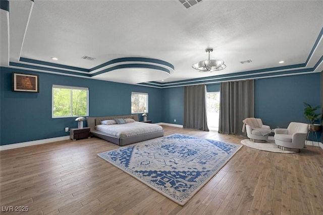2209 Purple Majesty Ct, Las Vegas, NV 89117 - bedroom featuring a tray ceiling, a chandelier, wood finished floors, a textured ceiling, and recessed lighting