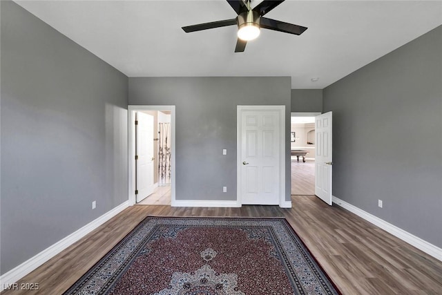 2209 Purple Majesty Ct, Las Vegas, NV 89117 - unfurnished bedroom featuring wood finished floors and a ceiling fan