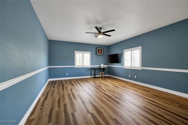 2209 Purple Majesty Ct, Las Vegas, NV 89117 - empty room with healthy amount of natural light, a ceiling fan, and wood finished floors