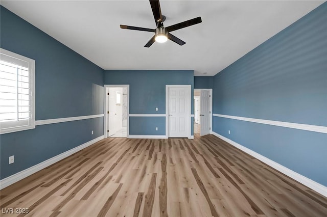 2209 Purple Majesty Ct, Las Vegas, NV 89117 - unfurnished bedroom featuring wood finished floors, connected bathroom, and a ceiling fan