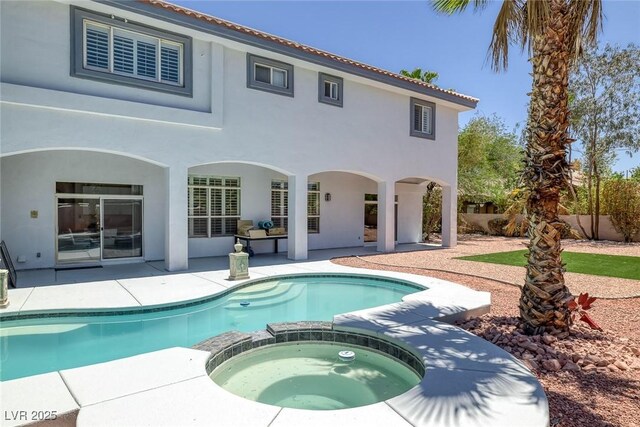 2209 Purple Majesty Ct, Las Vegas, NV 89117 - back of house with a patio area, stucco siding, and a pool with connected hot tub