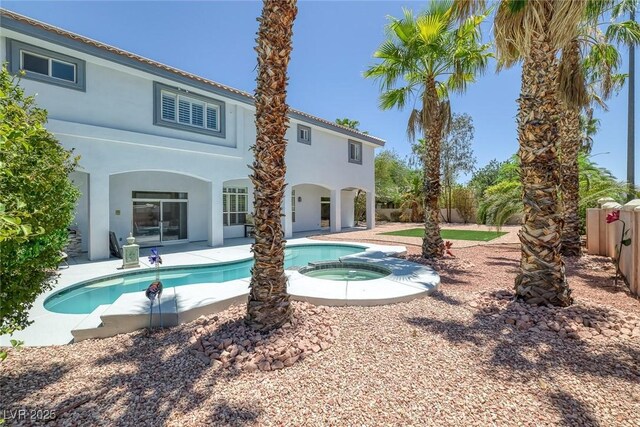 2209 Purple Majesty Ct, Las Vegas, NV 89117 - rear view of property featuring stucco siding, a patio area, and a pool with connected hot tub