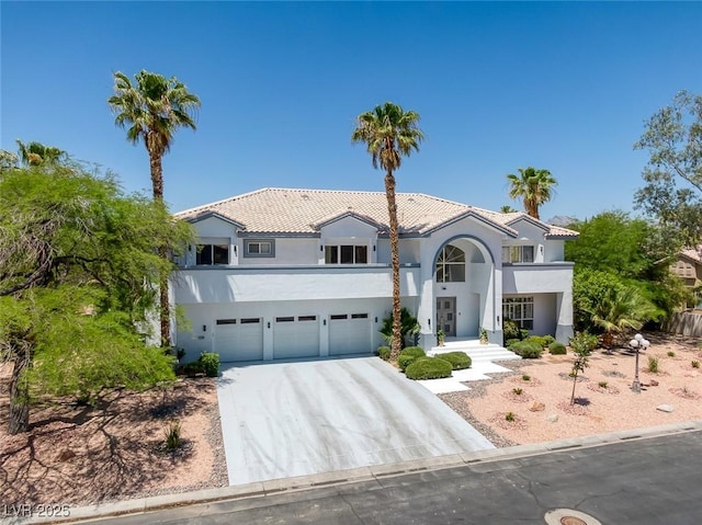 2209 Purple Majesty Ct, Las Vegas, NV 89117 - mediterranean / spanish house featuring a garage, stucco siding, concrete driveway, and a tiled roof