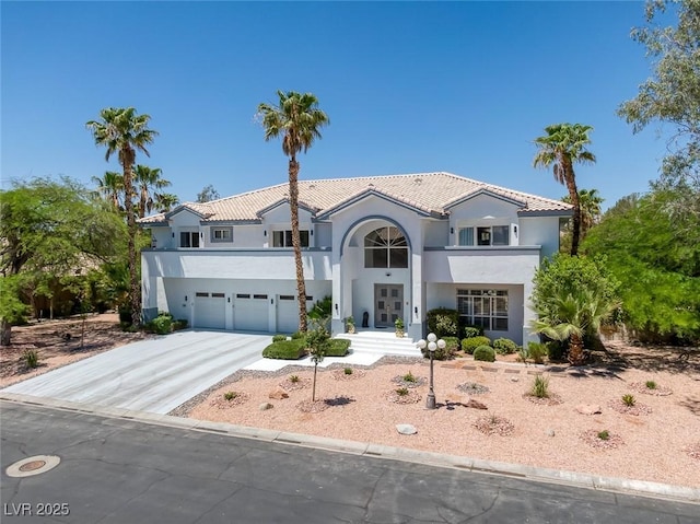 2209 Purple Majesty Ct, Las Vegas, NV 89117 - mediterranean / spanish-style house featuring an attached garage, stucco siding, driveway, french doors, and a tile roof