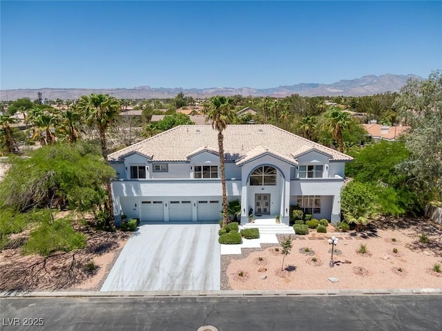 2209 Purple Majesty Ct, Las Vegas, NV 89117 - mediterranean / spanish home featuring concrete driveway, stucco siding, a mountain view, and a garage