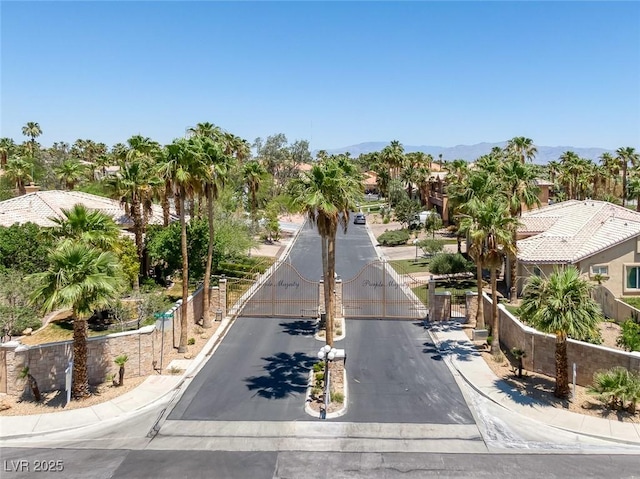 2209 Purple Majesty Ct, Las Vegas, NV 89117 - view of asphalt street featuring a gate, a gated entry, sidewalks, and curbs