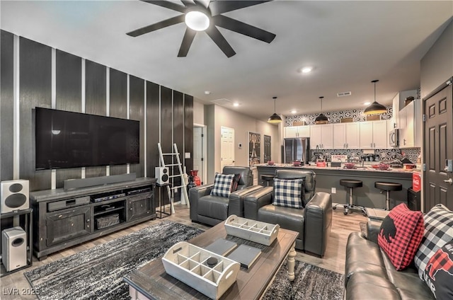 7472 Garnet Moon St, North Las Vegas, NV 89084 - living area with a ceiling fan and light wood-style flooring
