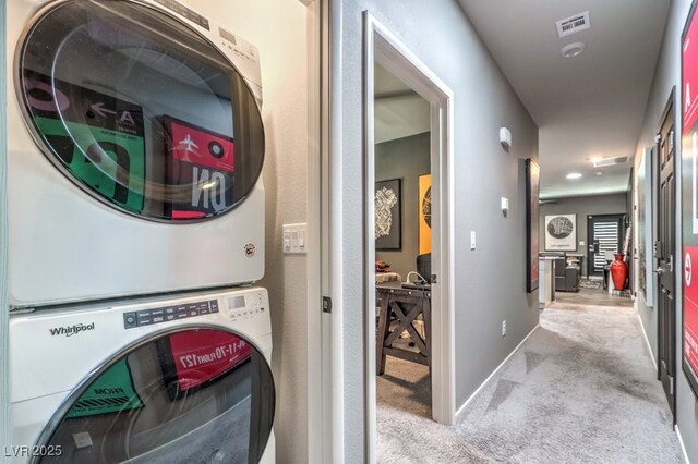 7472 Garnet Moon St, North Las Vegas, NV 89084 - laundry area featuring stacked washing machine and dryer and carpet floors