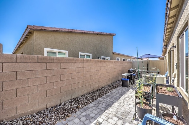 7472 Garnet Moon St, North Las Vegas, NV 89084 - fenced backyard featuring a patio and a garden