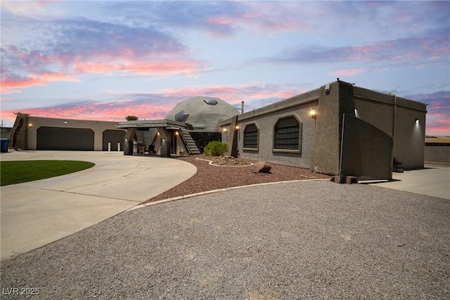 7215 Ullom Dr, Las Vegas, NV 89118 - view of front of home featuring curved driveway, stucco siding, and a garage