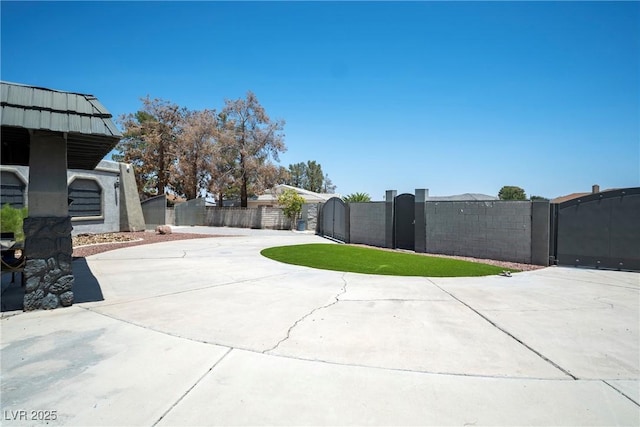 7215 Ullom Dr, Las Vegas, NV 89118 - view of patio with a gate and curved driveway