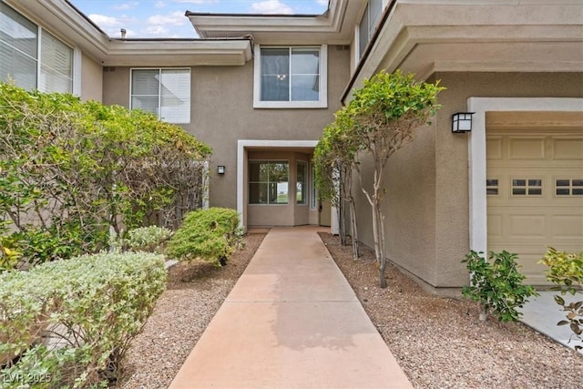 664 Peachy Canyon Cir Unit 103, Las Vegas, NV 89144 - view of exterior entry featuring stucco siding and a garage