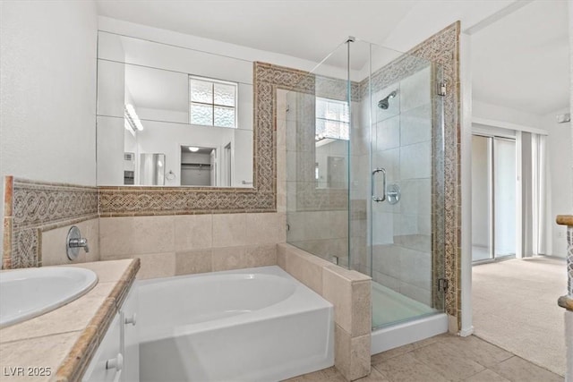 664 Peachy Canyon Cir Unit 103, Las Vegas, NV 89144 - full bathroom featuring a bath, a shower stall, vanity, and tile patterned flooring