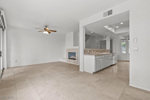 664 Peachy Canyon Cir Unit 103, Las Vegas, NV 89144 - unfurnished living room featuring a ceiling fan, a fireplace, recessed lighting, and light tile patterned floors