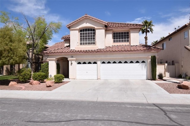 1700 Double Arrow Pl, Las Vegas, NV 89128 - mediterranean / spanish-style home with an attached garage, a tile roof, concrete driveway, and stucco siding