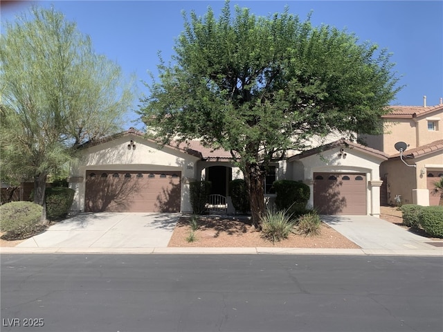 3328 White Bark Pine St, Las Vegas, NV 89129 - mediterranean / spanish home with concrete driveway, an attached garage, and stucco siding